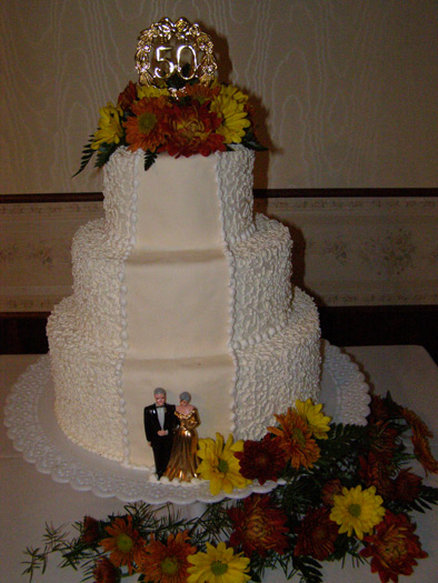 Romantic anniversary cake with elegant piping and floral accents
