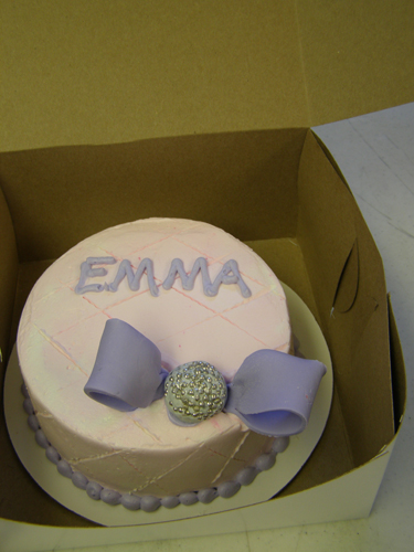 Gift-wrapped novelty cake topped with a large fondant bow