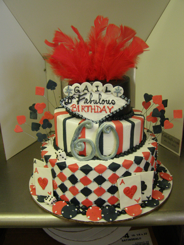 Casino-themed specialty cake with playing cards and dice decorations