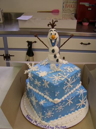 Frozen-themed birthday cake with winter wonderland decorations
