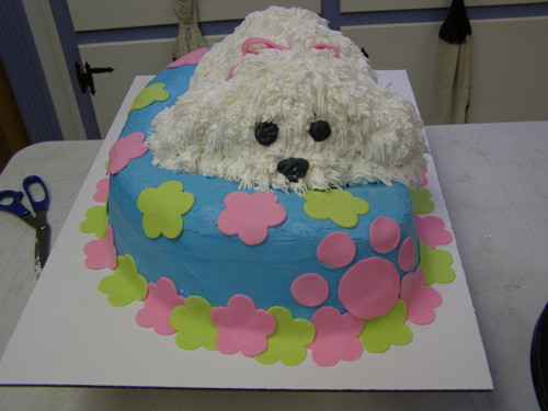 Adorable puppy dog shaped cake with realistic fur texture frosting
