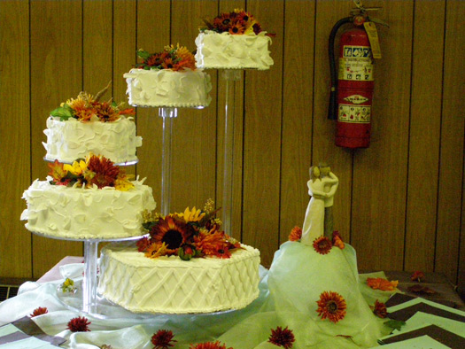 Wedding cake on display at a reception venue by Lisa Becker's Bakery