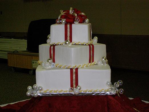 Wedding cake adorned with fresh floral arrangements by Lisa Becker's Bakery